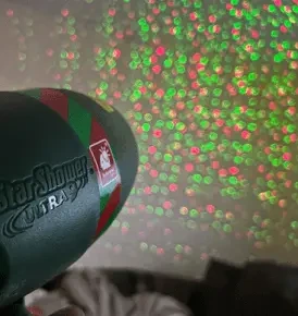 Star Shower Ultra 9 projecting on wall in red and green